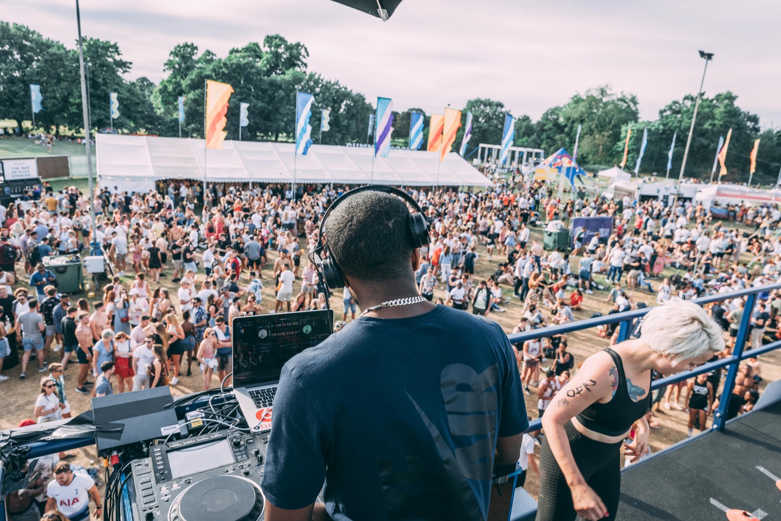 DJ T-Russ overlooking a large outdoor live-event crowd