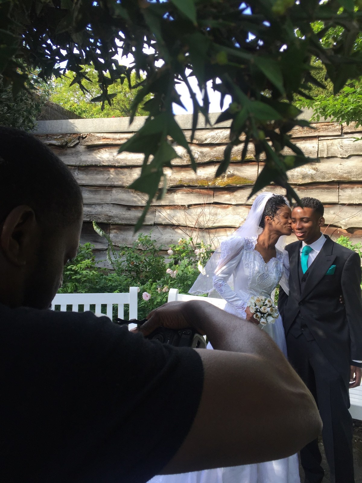 A wedding couple embracing outdoors